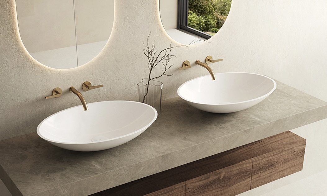 MARMY oval vessel washbasins with brushed gold taps